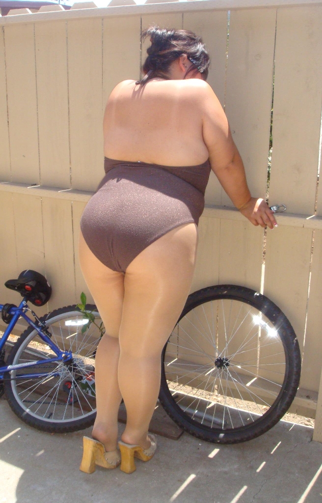 Brunette BBW wearing Tan Nylon Sheer Shiny Tights and Purple Swimsuit